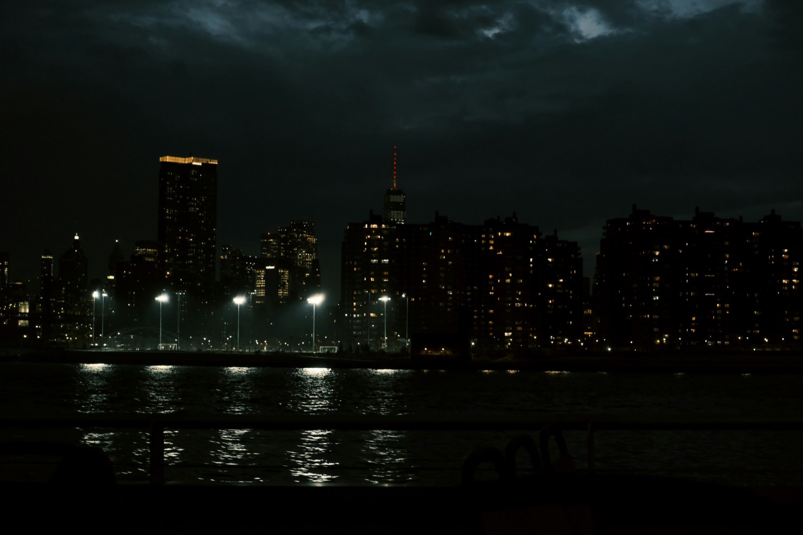 City skyline at night with a few lit windows